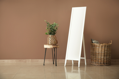 Large mirror and houseplants near color wallの写真素材