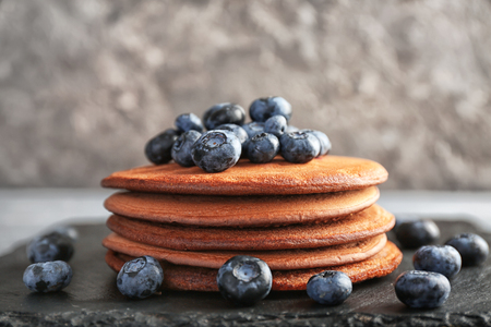 Tasty chocolate pancakes with blueberries on slate plateの写真素材