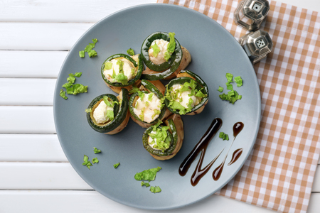 Tasty zucchini rolls with cheese on plateの写真素材