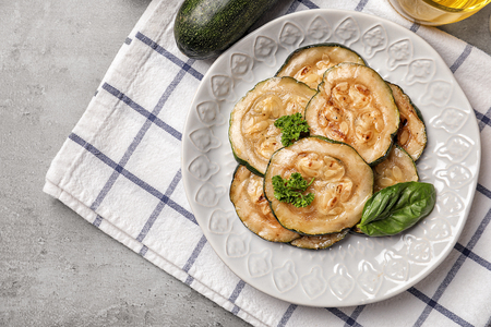 Plate with tasty grilled zucchini on grey tableの写真素材