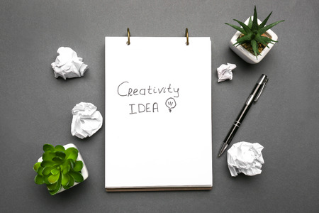 Notebook with text and crumpled paper on dark backgroundの写真素材