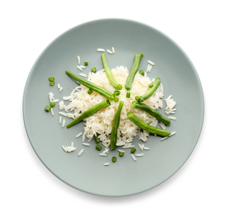Plate with tasty boiled rice and green bean on white backgroundの写真素材