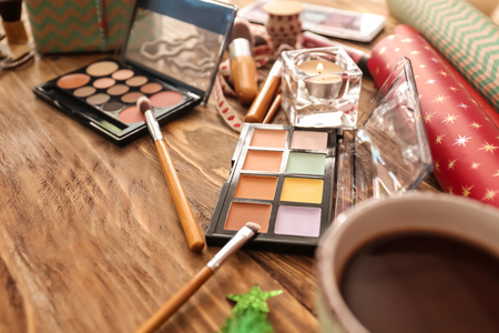 Set of cosmetics with decor for Christmas gifts on wooden tableの写真素材