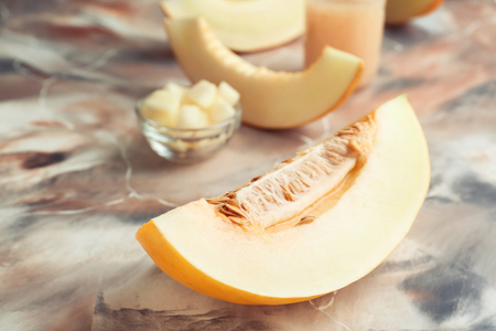 Piece of ripe melon on color tableの写真素材
