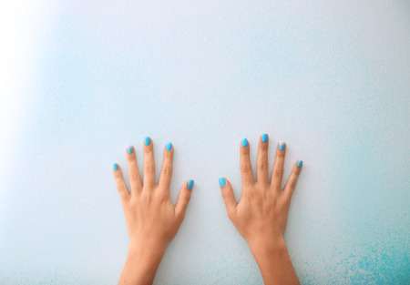 Hands of woman with professional manicure on light backgroundの写真素材