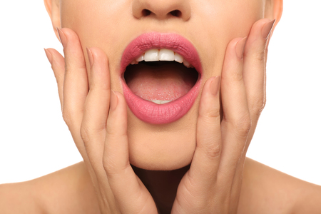 Beautiful young woman with pink lipstick on white background, closeupの写真素材