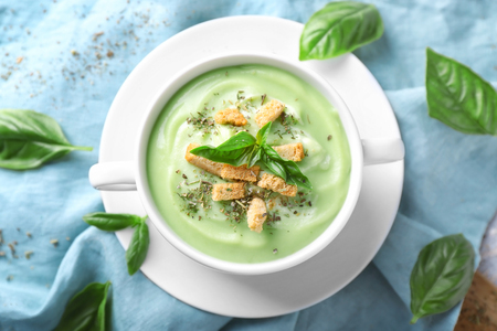 Pot with delicious zucchini soup on tableの写真素材