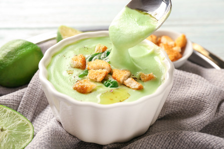 Eating of delicious zucchini soup from bowl, closeupの写真素材