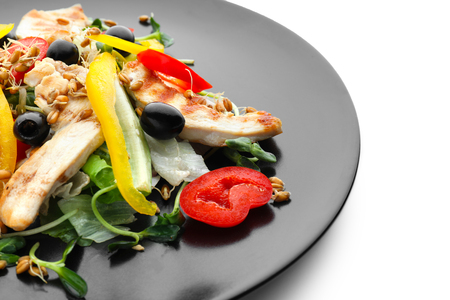 Plate with delicious chicken salad on white backgroundの写真素材