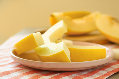 Plate with ripe sliced melon on table, closeupの写真素材