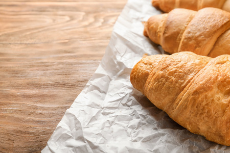 Tasty croissants on wooden tableの写真素材