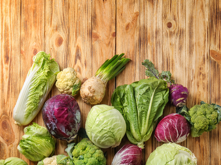 Different types of cabbage on wooden backgroundの写真素材