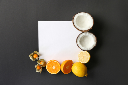 Composition with various delicious exotic fruits and blank card on dark backgroundの写真素材