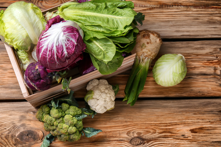 Crate with different types of cabbage on wooden backgroundの写真素材