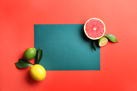 Composition with various delicious fruits and blank card on color backgroundの写真素材
