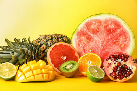 Various delicious fruits on color backgroundの写真素材