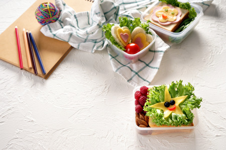 Lunch boxes with appetizing sandwiches on white textured backgroundの写真素材