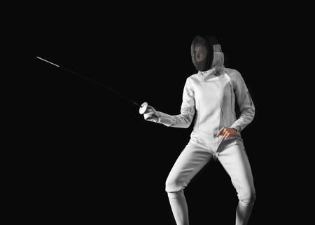 Young female fencer on dark backgroundの写真素材