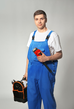 Handsome plumber on grey backgroundの写真素材