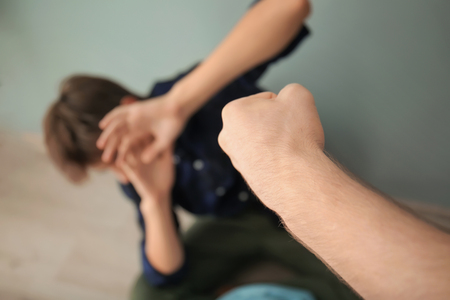 Aggressive teenager bullying boy indoors, closeupの写真素材