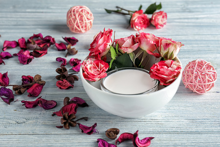 Bowl with cream and flowers on light wooden tableの写真素材