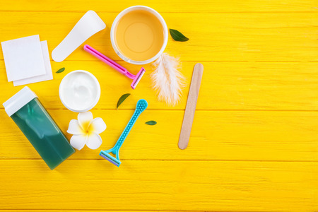 Set for hair removing on color wooden background