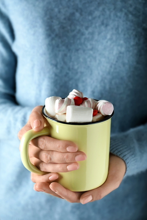 Woman with cup of tasty cocoa and marshmallows, closeupの写真素材