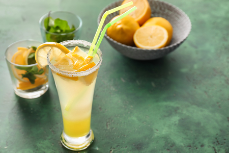 Glass of fresh lemonade on color tableの写真素材