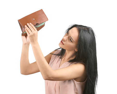 Young woman with empty wallet on white background