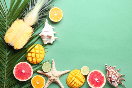 Flat lay composition with various delicious fruits on color backgroundの写真素材