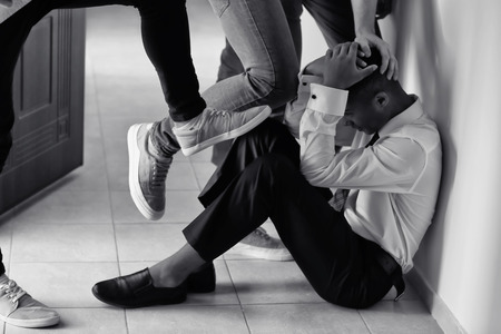 Teenagers bullying African-American boy at schoolの写真素材