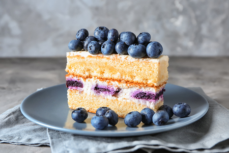 Piece of delicious blueberry cake on plateの写真素材