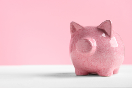 Piggy bank on light wooden tableの写真素材