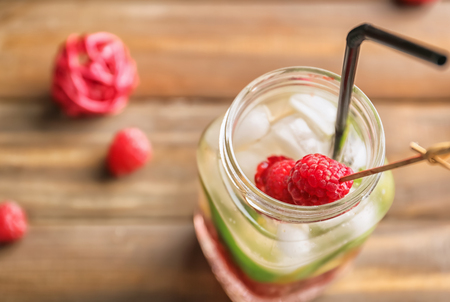 Mason jar of fresh raspberry lemonade on wooden tableの写真素材