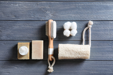 Bath products with loofah and brush on dark wooden tableの写真素材