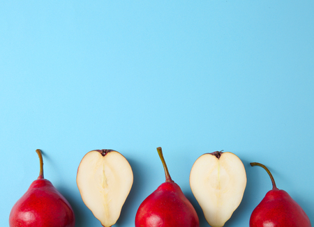 Tasty ripe pears on color background