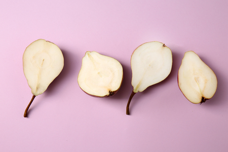 Halves of tasty ripe pears on color backgroundの写真素材
