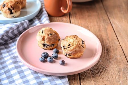 Tasty blueberry muffins on plateの写真素材