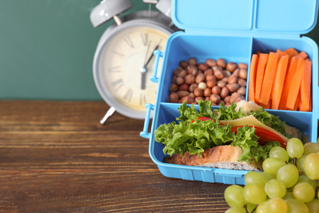 Lunch box with appetizing food on wooden tableの写真素材