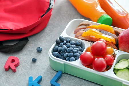 Lunch box with appetizing food on grey tableの写真素材