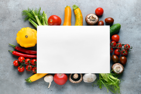 Composition with fresh vegetables and blank card for text on grey backgroundの写真素材