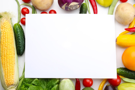 Composition with various fresh vegetables and blank card on white backgroundの写真素材