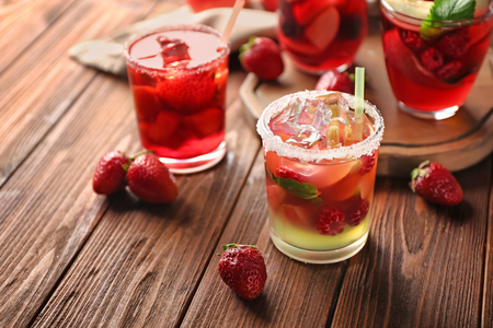 Fresh summer cocktails in glasses on wooden tableの写真素材