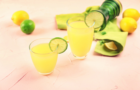 Glasses of fresh lemon juice on color backgroundの写真素材