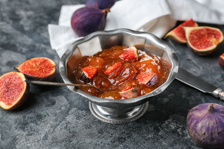 Bowl of tasty fig jam on grey tableの写真素材