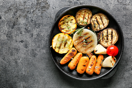 Pan with tasty grilled vegetables on grey tableの写真素材