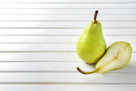 Sweet ripe pears on light wooden tableの写真素材
