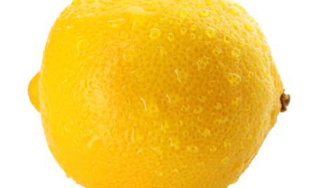 Ripe whole lemon with drops on white background, closeupの写真素材
