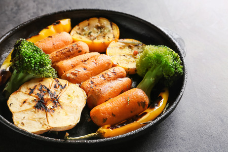 Pan with tasty grilled vegetables on grey tableの写真素材