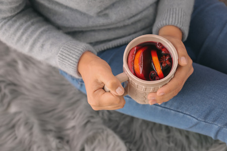 Woman holding cup of delicious mulled wine, closeupの写真素材